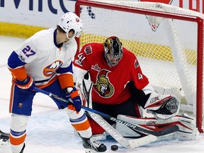 Ottawa Senators goalie Craig Anderson (41) makes a save on New York Islanders left wing Anders Lee (27) during third period NHL hockey action in Ottawa on, Saturday Feb. 11, 2017. THE CANADIAN PRESS/Fred Chartrand