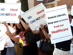Outside an advance polling station for the Scarborough Rouge River by-election, a group of doctors held a small demo pushing for the Ontario government to make changes in healthcare on Saturday August 20, 2016. (Michael Peake/Toronto Sun)