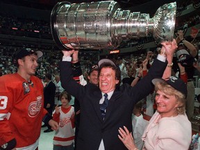 In this June 17. 1998, file photo, Detroit Red Wings owner Mike Ilitch, middle, hoists the Stanley Cup in Washington after the Red Wings won their second consecutive NHL championship. (Julian H. Gonzalez/Detroit Free Press via AP)