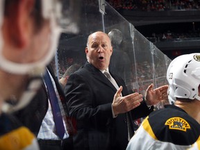Head coach Claude Julien of the Boston Bruins gives instructions to Brandon Carlo during a game against the New Jersey Devils at the Prudential Center on January 2, 2017. (Bruce Bennett/Getty Images)