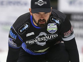 Skip Reid Carruthers checks his line during the Viterra provincial men’s curling championship at the Stride Centre in Portage la Prairie. Carruthers topped the McEwen rink 4-2 Saturday night. (Kevin King/Winnipeg Sun)