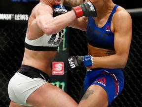 Holly Holm (left) exchanges punches with Germaine de Randamie in their UFC women’s featherweight championship bout during UFC 208 at the Barclays Center on February 11, 2017 in Brooklyn. (Anthony Geathers/Getty Images)