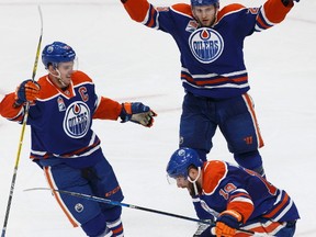 Edmonton's Patrick Maroon (19) celebrates a goal with Connor McDavid (97) and Leon Draisaitl (29) during the third period of a NHL game between the Edmonton Oilers and the New Jersey Devils in Edmonton, Alberta on Thursday, January 12, 2017. Ian Kucerak / Postmedia