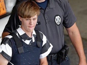 In this June 18, 2015 file photo, Charleston, S.C., Dylann Roof is escorted from the Cleveland County Courthouse in Shelby, N.C.  (AP Photo/Chuck Burton, File)