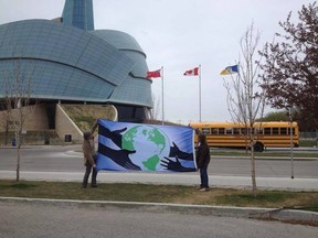 Bruce Benson (right) holds his Flag of Humanity with his son Jackson in front of the Canadian Museum of Human Rights in Winnipeg.
SUBMITTED PHOTO/Handout