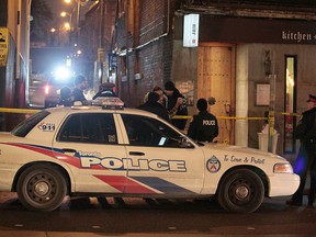 Toronto Police respond to a restaurant near Queen St. W. and Roncesvalles Ave. after a man, 20. was shot in the kitchen on Saturday, Feb. 12, 2017. (John Hanley photo)