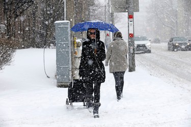 Pedestrians on Avenue Rd south of St Clair  during a Sunday morning snowfall on Sunday February 12, 2017. Michael Peake/Toronto Sun/Postmedia Network