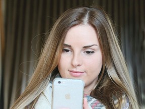 Morgan Palmer, 24, uses a mobile dating app to view online profiles on Monday, Feb. 6, 2017. Many traditional dating apps allow the viewer to only see the profile pictures, but with a new app called Zepeel you can view a video profile as well as talk to the person directly. (VERONICA HENRI/TORONTO SUN)