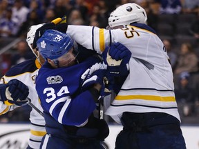 Toronto Maple Leafs forward Auston Matthews mixes it up with Rasmus Ristolainen of the Buffalo Sabres at the Air Canada Centre on Feb. 11, 2017. (Michael Peake/Toronto Sun/Postmedia Network)