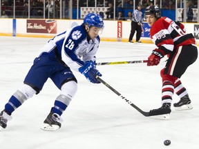 Ottawa 67s' Peter Stratis tries to stop Sudbury Wolves' Drake Pilon during the game Sunday February 12, 2017 at TD Place Arena. Ashley Fraser/Postmedia