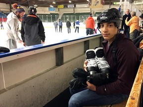 Syrian refugee Mohamed Maree, 16, relaxes on a bench at the Memorial Centre after skating for the first time on Sunday. (Steph Crosier/The Whig-Standard)