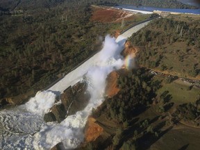 This Saturday, Feb. 11, 2017, aerial photo released by the California Department of Water Resources shows the damaged spillway with eroded hillside in Oroville, Calif. (William Croyle/California Department of Water Resources via AP)