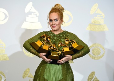 Adele poses in the press room with the awards for album of the year for "25", song of the year for "Hello", record of the year for "Hello", best pop solo performance for "Hello", and best pop vocal album for "25" at the 59th annual Grammy Awards at the Staples Center on Sunday, Feb. 12, 2017, in Los Angeles. (Photo by Chris Pizzello/Invision/AP) ORG XMIT: CACJ374