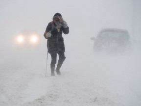 A pedestrian walks down Brunswick Street near Citadel Hill in Halifax as a major winter storm blasts the Maritimes on Monday, Feb. 13, 2017. (Andrew Vaughan/The Canadian Press)
