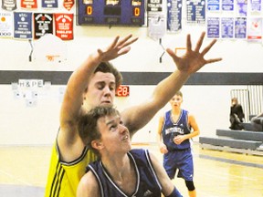 Jack Dixon of the Mitchell District High School (MDHS) junior boys basketball team looks to go up for a basket but is impeded by the defence of this St. Michael opponent during action from the Huron-Perth quarter-final last Wednesday, Feb. 8, a 37-21 loss. ANDY BADER/MITCHELL ADVOCATE