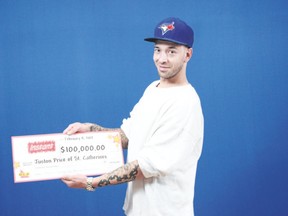 The Niagara Regional Police have a warrant out for the arrest of Juston Price of St. Catharines. He is seen in the OLG photo after collecting a $100,000 cheque for winning the scratch-off lottery game Boom Multiplier earlier this month. Supplied photo