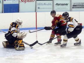 Tavistock Braves goalie Ben Larder makes a save on Paris Mounties forward Richard Brooks, centre, in Tavistock, Ont. on Sunday February 12, 2017 during their Provincial Junior Hockey League quarter-final series. Paris won 4-1 and will host Game 7 Tuesday night. (Greg Colgan/Woodstock Sentinel-Review/Postmedia Network)