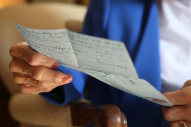 Joan McTavish reads one of the 1,000 letters between her and her then future husband, Ian. (STAN BEHAL/TORONTO SUN)