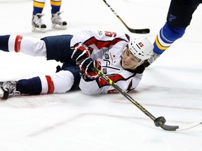 Washington Capitals' Andre Burakovsky, of Austria, tries to pass the puck after falling to the ice during an NHL game against the St. Louis Blues on Jan. 19, 2017. (AP Photo/Jeff Roberson)