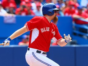 Adam Lind of the Toronto Blue Jays singles during an MLB game against the Milwaukee Brewers at the Rogers Centre in Toronto on July 1, 2014. (Dave Abel/Toronto Sun)