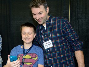 Former NHL tough guy John Scott poses for a selfie taken by Aiden Anderson during a reception for kids from the Thames Valley Children?s Centre at the Western Fair Agriplex on Monday. (MORRIS LAMONT, The London Free Press)