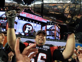 Nolan MacMillan of the Ottawa Redblacks hoists the Grey Cup after beating the Calgary Stampeders at BMO Field on Nov. 27, 2016. (Vaughn Ridley/Getty Images)