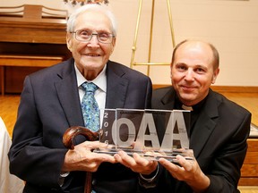 John Stefura, is presented the OAA Land mark award by Father Peter Bodnar, pastor at Saint Mary's Ukrainian Catholic Church on June 15, 2016. The church held some tours and a celebration as the Ontario Association of Architects presented the  Landmark award to Stefura, whose archtectual firm designed the church 1969. Stefua died on Friday. Gino Donato/Sudbury Star