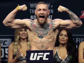 In this Nov. 11, 2016, file photo, Conor McGregor stands on a scale during the weigh-in event for his fight against Eddie Alvarez in UFC 205 mixed martial arts at Madison Square Garden in New York.