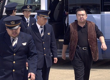 In this May 4, 2001, photo, a man believed to be Kim Jong Nam, right, the eldest son of then North Korean leader Kim Jong Il, walks out of a police van to board a plane to Beijing at Narita international airport in Narita, northeast of Tokyo. Malaysian officials say a North Korean man has died after suddenly becoming ill at Kuala Lumpur's airport. The district police chief said Tuesday Feb. 14, 2017 he could not confirm South Korean media reports that the man was Kim Jong Nam, the older brother of North Korean leader Kim Jong Un.??   (Kyodo News via AP) ORG XMIT: TKTT805