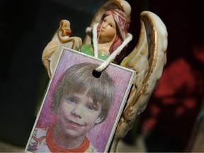 In this May 28, 2012 file photo, an image of Etan Patz hangs on an angel figurine, part of a makeshift memorial in the SoHo neighborhood of New York where the boy lived. Pedro Hernandez, a man unsuspected for decades in one of the nation's most haunting missing-child cases, has been convicted nearly 38 years after six-year-old Patz disappeared in New York City. (AP/PHOTO)