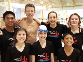 Ten members of the Sarnia Y Rapids 1 swim team had first-place finishes at a St. Clair Erie Aquatic League meet in Leamington. Back row from left are Mark deGuzman, Drake Landon, Diane Clarke and Taylor Marut. Front row from left are Kate Bedard, Lauren Armstrong and Emmanuel deGuzman. Absent are Darius Landon, Reed Mathieson and Hayden Wittliff. (Handout/Sarnia Observer/Postmedia Network)