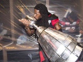 Ottawa Redblacks defensive back Abdul Kanneh (14) kisses the Grey Cup as he celebrates his team’s win over the Calgary Stampeders on Sunday, November 27, 2016 in Toronto. (THE CANADIAN PRESS/Nathan Denette)