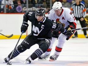 New York Islanders centre John Tavares (91) pushes past Ottawa Senators defenceman Dion Phaneuf Sunday, Dec. 18, 2016, in New York. (AP Photo/Kathy Willens)