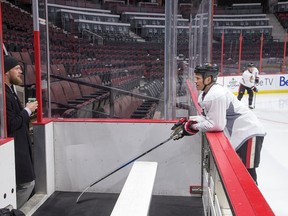 Buffalo Sabres goalie Robin Lehner chats with Chris Neil as the Ottawa Senators practice at Canadian Tire Centre in advance of a game against the Buffalo Sabres on Feb. 14, 2017. (Wayne Cuddington/ Postmedia)