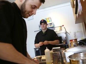 Canadian Forces veteran Scott Snow and chef Francois Drolet work in the kitchen of Bayview Farm Restaurant on Tuesday. (Elliot Ferguson/The Whig-Standard)