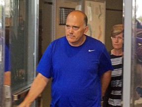 Former Peel Regional Police officer Craig Wattier, 52, who spent 31 years on the force, pleaded guilty Tuesday to fraud over $5,000 and breach of trust charges based on accessing the pornography. He is pictured leaving court in 2015. (TORONTO SUN/FILES)