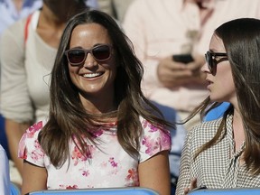 In this Friday, June 19, 2015 file photo, Pippa Middleton, left, the sister of Kate, the Duchess of Cambridge, watches the quarterfinal tennis match between Canada's Milos Raonic and France's Gilles Simon on the fifth day of the Queen's Championships in London. (AP Photo/Tim Ireland, File)