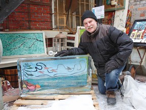 David Dossett, local artist, poses for a photo with one of the 20 pieces of artwork, Coming Home by Lori Kallay, in the 2017 show. Froid'Art — Art on Ice is a unique showcase of local artwork in the winter and will continue to run as long as the ice stays in Kingston on Thursday. (Julia McKay/The Whig-Standard)