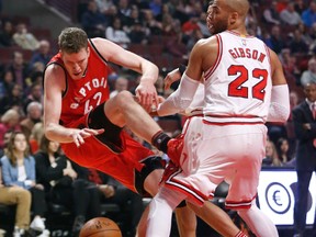 Toronto Raptors' Jakob Poeltl is fouled by Chicago Bulls' Taj Gibson during an NBA game on Feb. 14, 2017, in Chicago. (AP Photo/Charles Rex Arbogast)