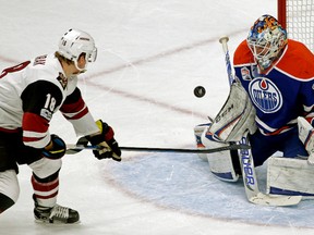 Edmonton Oilers goalie Cam Talbot makes a save on this shot by Arizona Coyotes Christian Dvorak (left) during first period NHL game action in Edmonton on February 14, 2017.
