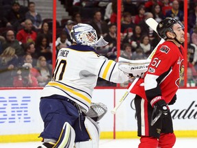 Mark Stone of the Ottawa Senators gets hit hard by Robin Lehner of the Buffalo Sabres during an NHL game at Canadian Tire Centre on Feb. 14, 2017. (Jean Levac/Postmedia)