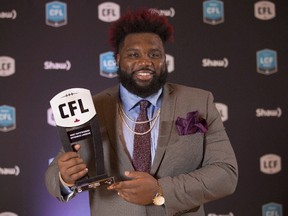 Calgary Stampeders offensive lineman Derek Dennis poses backstage after being named Most Outstanding Offensive Lineman at the CFL Awards in Toronto on Nov. 24, 2016. (THE CANADIAN PRESS/Peter Power)