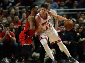 Raptors' Norman Powell defends against Chicago's Doug McDermott during Tuesday night's game. (GETTY IMAGES)