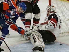 Edmonton Oilers Matt Hendricks (left) scores on Arizona Coyotes goalie Louis Domingue (right) during second period NHL game action in Edmonton on February 14, 2017.