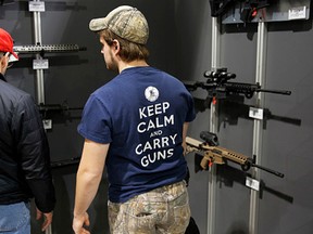 Visitors view a gun display at a National Rifle Association outdoor sports trade show on February 10, 2017 in Harrisburg, Pennsylvania. (AFP/DOMINICK REUTER)