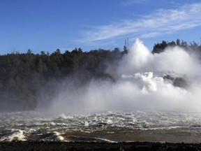 Water gushes from the Oroville Dam's main spillway Tuesday, Feb. 14, 2017, in Oroville, Calif. Crews working around the clock atop the crippled Oroville Dam have made progress repairing the damaged spillway, state officials said Tuesday. (AP Photo/Marcio Jose Sanchez)