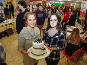 Julie Cameron, a culinary arts baking focus teacher, left, and Emily Carr, a culinary student heading to St. Lawrence College in the fall for culinary management, are seen at the Bayridge Secondary School expanded student opportunities showcase on Tuesday. (Julia McKay/The Whig-Standard)