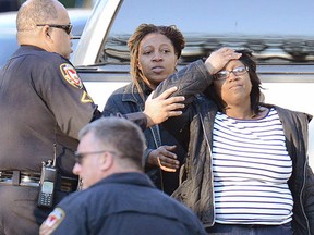 Neighbors react after a police officer has shot and killed a man Wednesday, Feb. 15, 2017, in Durham, N.C. It was the second shooting by law enforcement in Durham in the past three days. (Bernard Thomas/The Herald-Sun via AP)