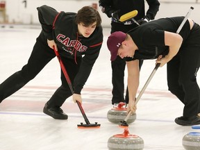 St. Charles' Max Cull (left) and Andrew Kohut sweep during the high school boys city curling final at Sudbury Curling Club on Wednesday. The Cardinals boys and the Lockerby girls claim gold medals. Gino Donato/The Sudbury Star