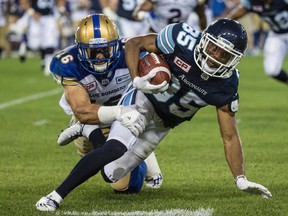 Toronto Argonauts' Diontae Spencer is tackled by Winnipeg Blue Bombers' Taylor Loffler during a CFL game on Aug. 12, 2016. (Craig Robertson/Toronto Sun/Postmedia Network)